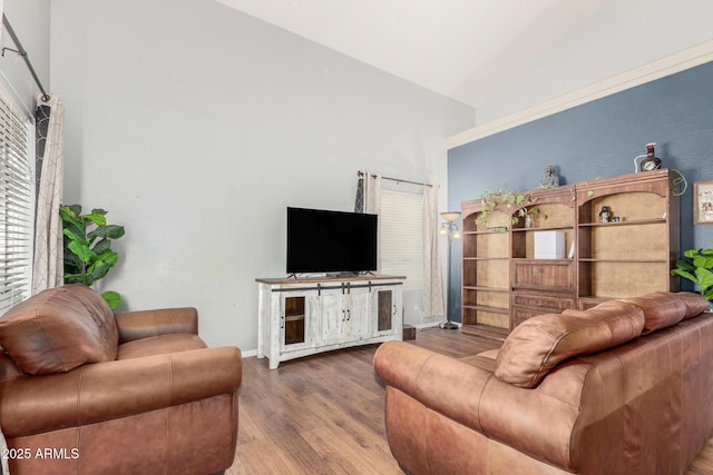 living area with baseboards, high vaulted ceiling, and wood finished floors