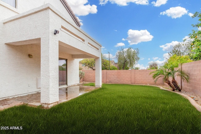 view of yard with a fenced backyard and a patio area