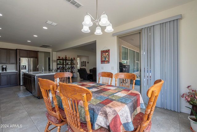 dining space with a notable chandelier and sink