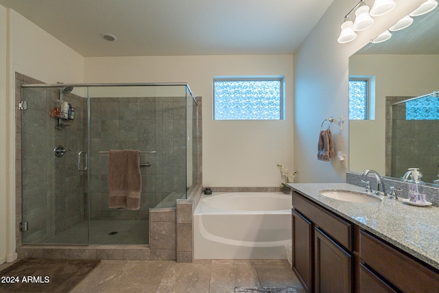 bathroom featuring tile patterned floors, a wealth of natural light, vanity, and shower with separate bathtub