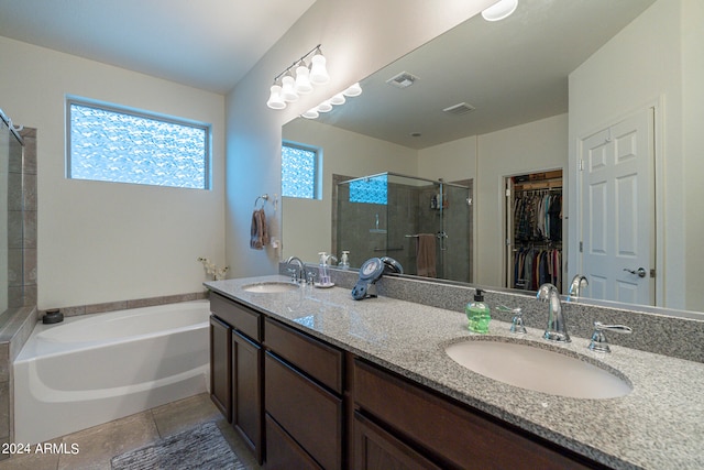 bathroom featuring independent shower and bath, vanity, and tile patterned flooring