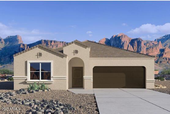 mediterranean / spanish house featuring a garage, driveway, a mountain view, and stucco siding