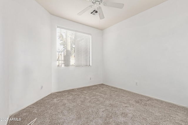 carpeted empty room featuring visible vents and ceiling fan