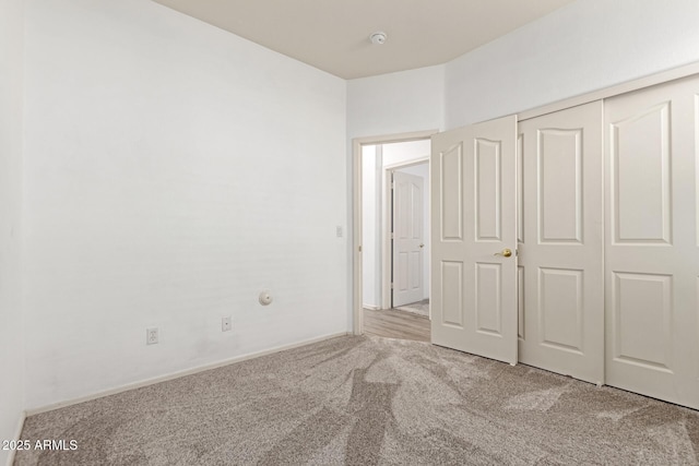 unfurnished bedroom with carpet and a closet