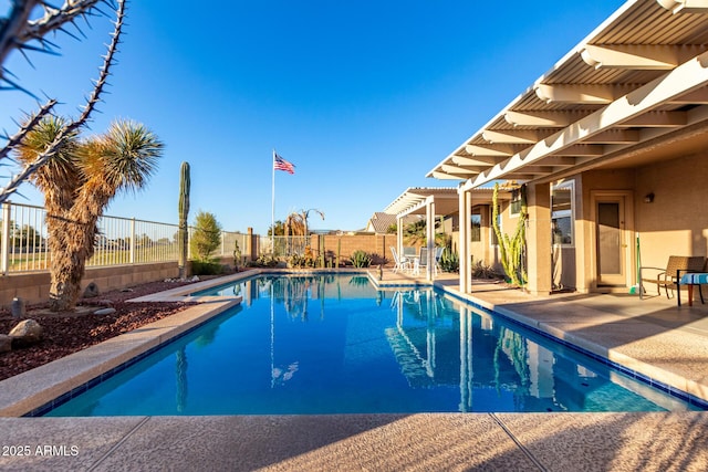 view of swimming pool featuring a fenced in pool, fence, a patio, and a pergola