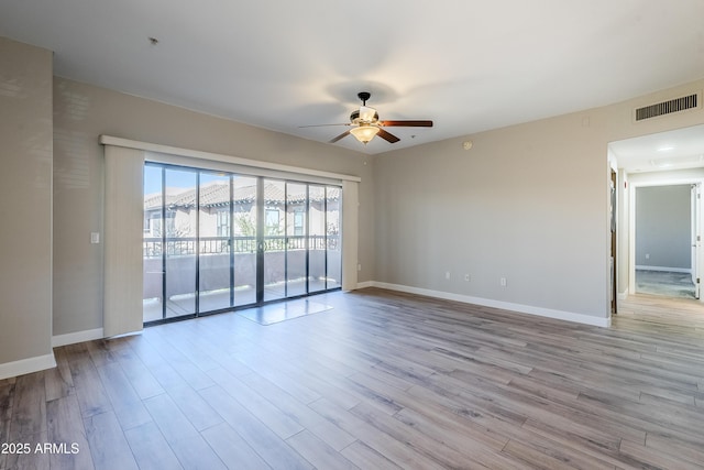 unfurnished room featuring ceiling fan and light wood-type flooring