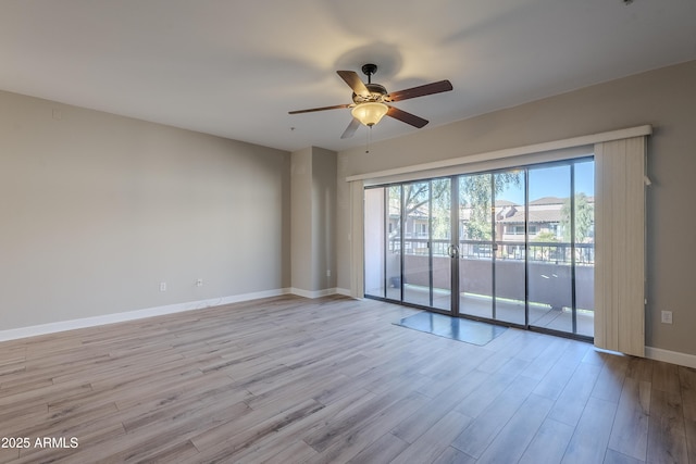 empty room featuring ceiling fan and light wood-type flooring