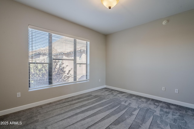 spare room featuring dark carpet