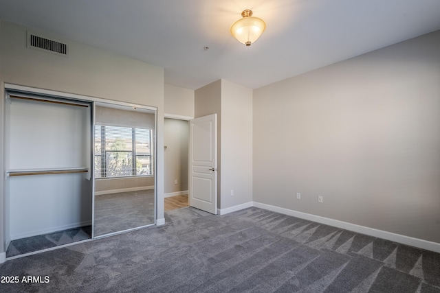 unfurnished bedroom with carpet flooring and a closet