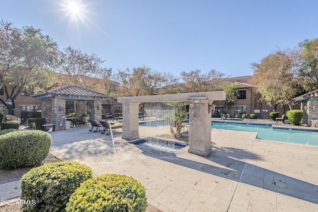 view of pool featuring a patio and a hot tub