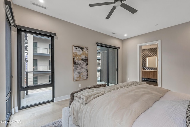 bedroom with baseboards, visible vents, light wood-style flooring, access to exterior, and ensuite bathroom