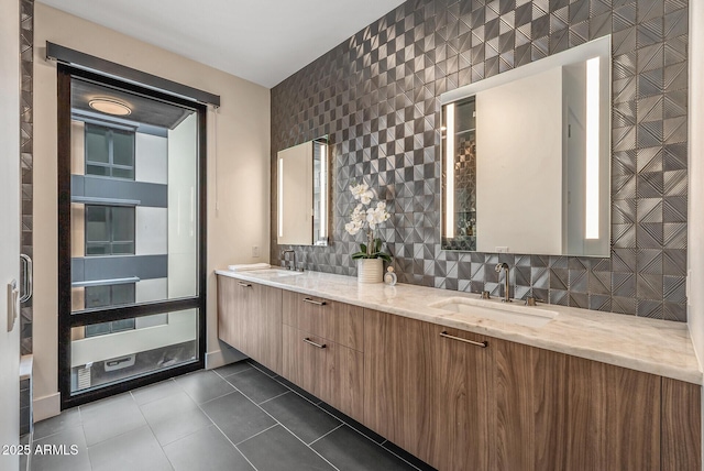 full bath with tile patterned floors, double vanity, backsplash, and a sink