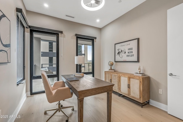 home office featuring recessed lighting, light wood-style floors, visible vents, and baseboards