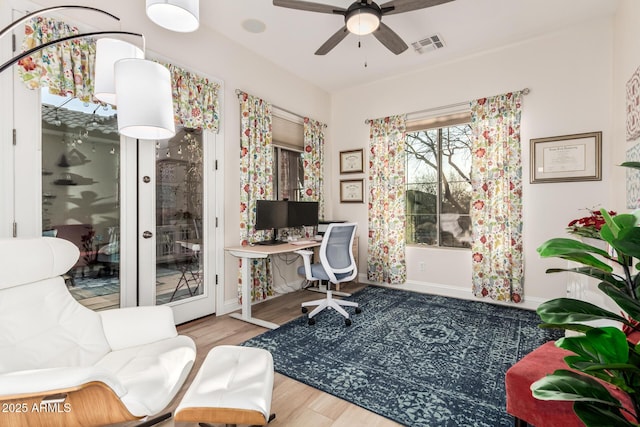 office with visible vents, wood finished floors, baseboards, ceiling fan, and french doors