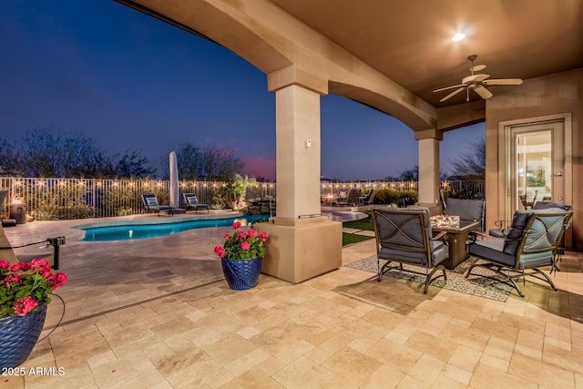 view of patio featuring a fenced in pool, a ceiling fan, a fire pit, and fence