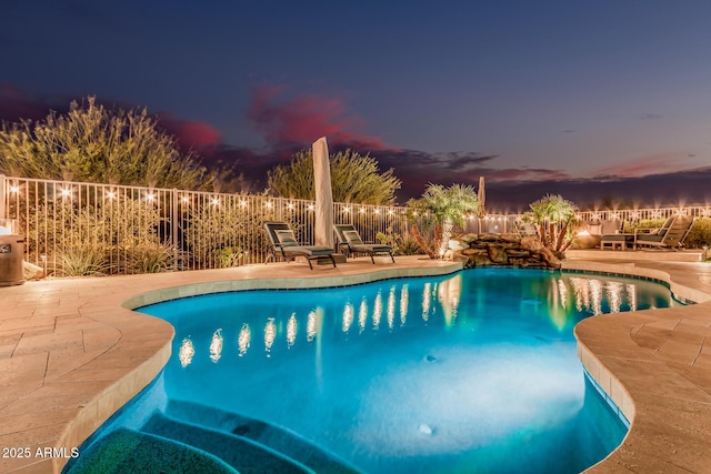 view of swimming pool with a patio, fence, and a fenced in pool