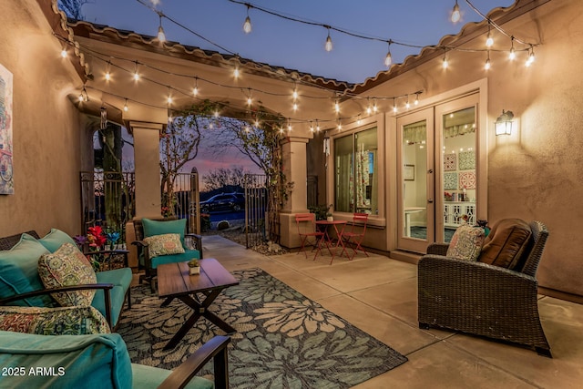 view of patio / terrace featuring french doors, fence, and outdoor lounge area