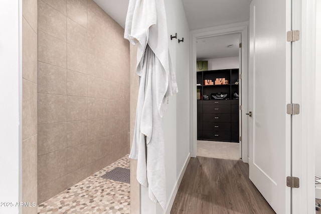 bathroom featuring tiled shower and hardwood / wood-style floors