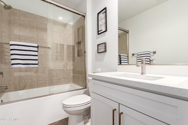 full bathroom featuring enclosed tub / shower combo, vanity, and toilet