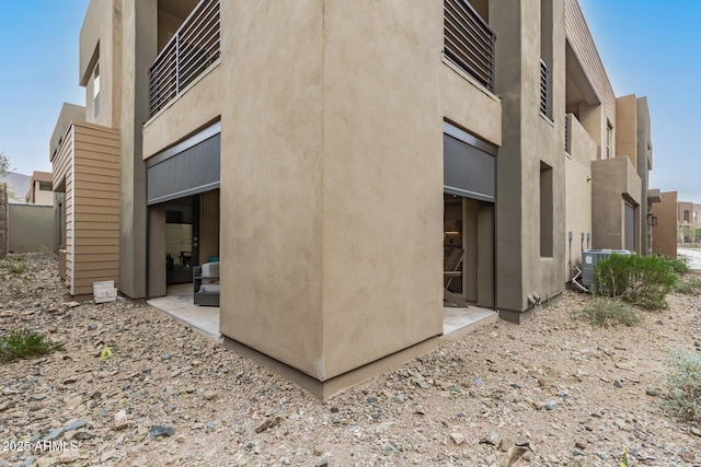 view of side of home featuring central AC unit