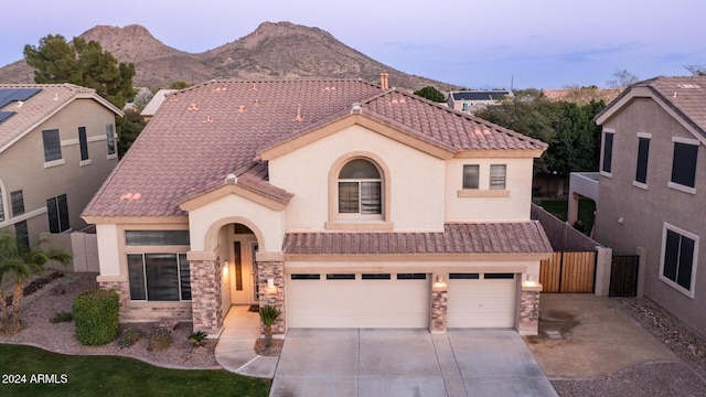 view of front facade featuring a mountain view and a garage