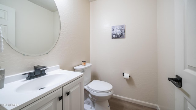 bathroom featuring hardwood / wood-style floors, vanity, and toilet