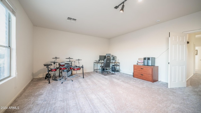 home office featuring light carpet and track lighting