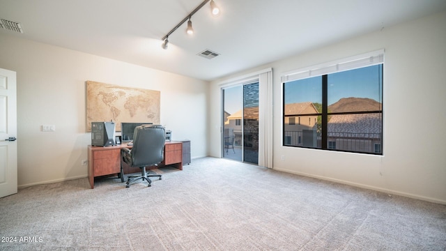 carpeted office featuring track lighting