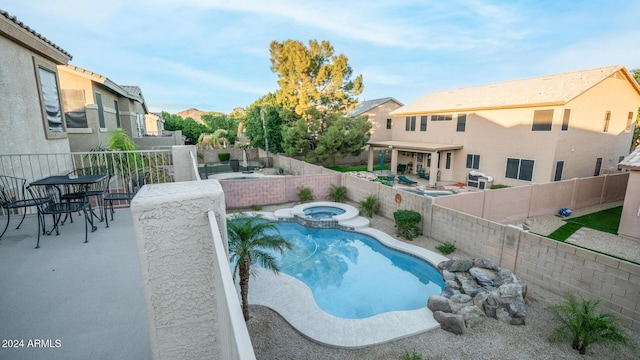 view of swimming pool featuring an in ground hot tub and a patio