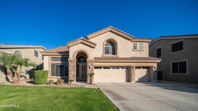 mediterranean / spanish-style house with a garage and a front lawn