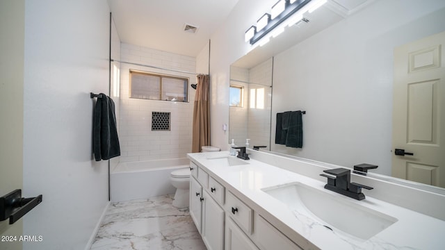 full bathroom featuring vanity, shower / tub combo, and toilet