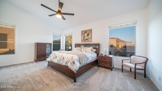 carpeted bedroom with ceiling fan and high vaulted ceiling