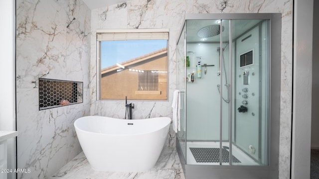 bathroom featuring shower with separate bathtub