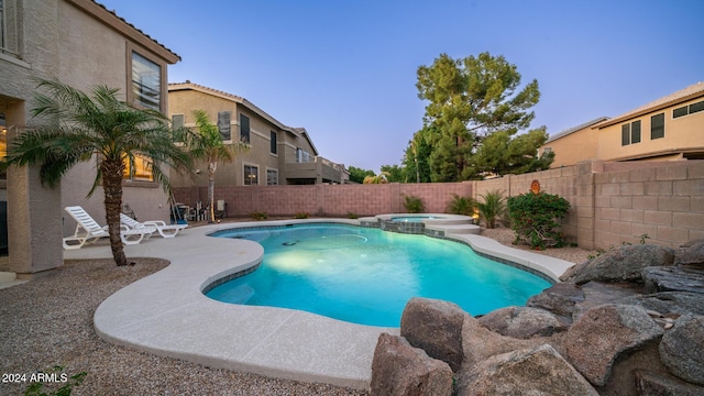 view of swimming pool featuring an in ground hot tub and a patio