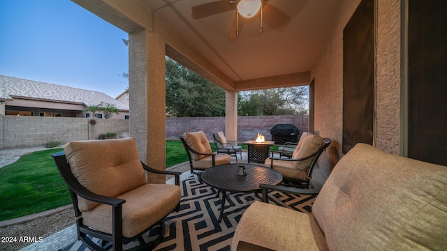 view of patio featuring an outdoor fire pit and ceiling fan