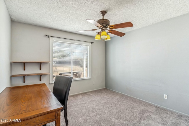 unfurnished office featuring baseboards, a textured ceiling, a ceiling fan, and carpet floors