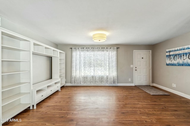 interior space featuring wood finished floors and baseboards