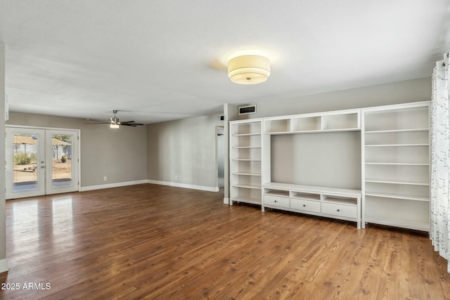 unfurnished living room featuring a ceiling fan, wood finished floors, visible vents, baseboards, and french doors