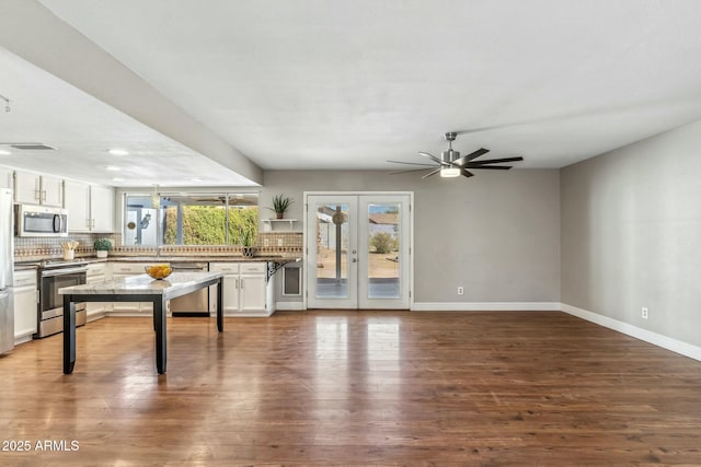 living area featuring ceiling fan, french doors, baseboards, and dark wood-style floors