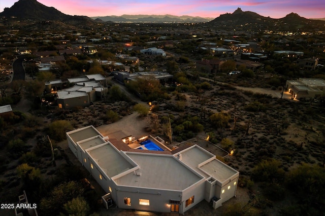 aerial view at dusk featuring a mountain view