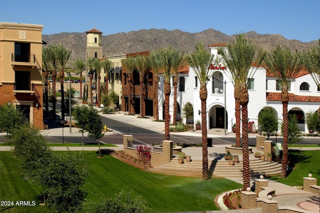 view of community with a lawn and a mountain view