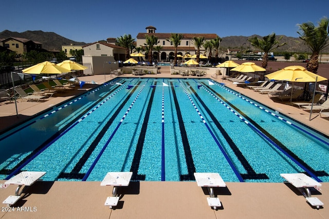 view of swimming pool featuring a mountain view and a patio area