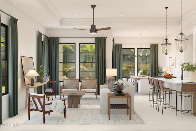 living room featuring ceiling fan with notable chandelier, a raised ceiling, and crown molding