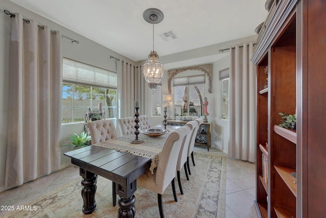 dining room featuring visible vents, an inviting chandelier, and light tile patterned flooring