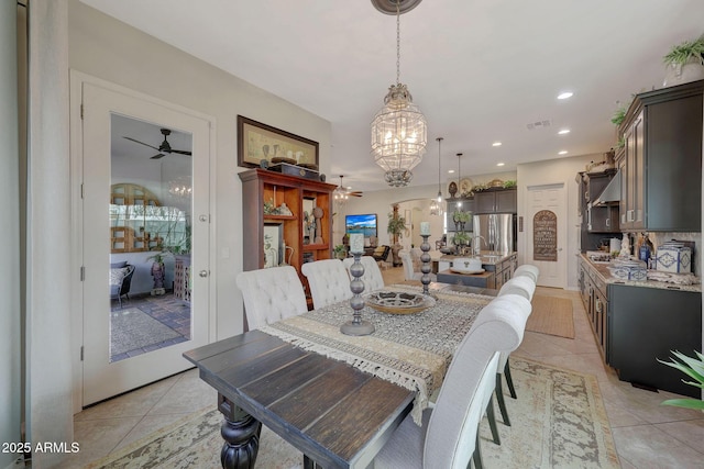 dining area featuring arched walkways, light tile patterned floors, recessed lighting, visible vents, and ceiling fan with notable chandelier