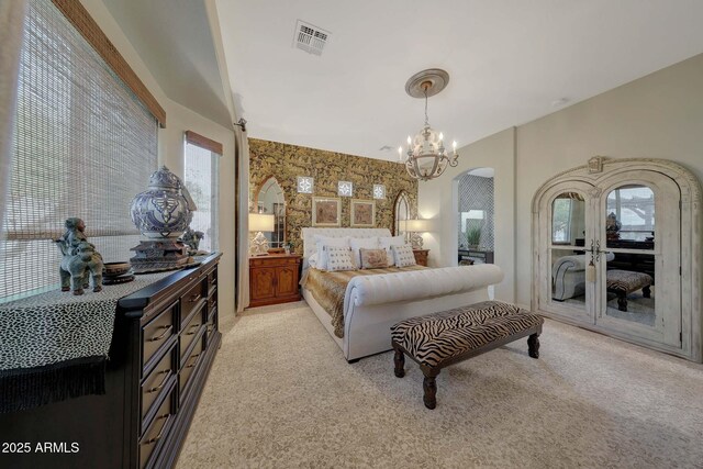 bedroom with arched walkways, light carpet, visible vents, multiple windows, and wallpapered walls