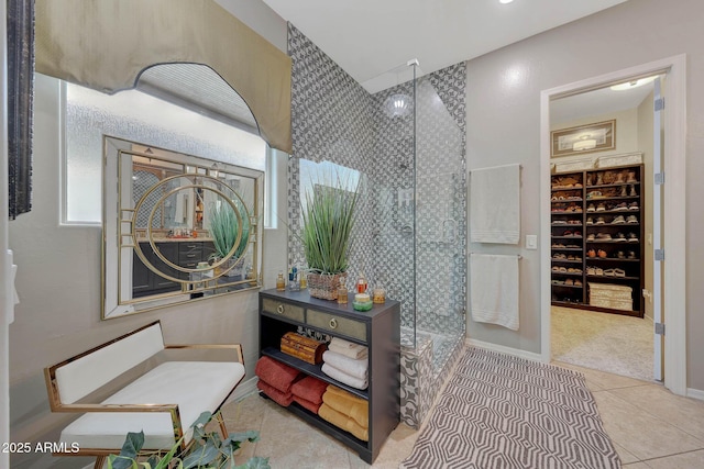 bathroom with a walk in shower and tile patterned floors