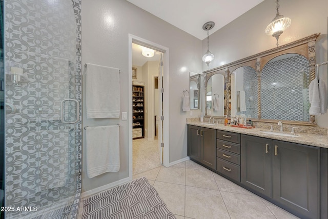 bathroom with tile patterned flooring, double vanity, a sink, and walk in shower