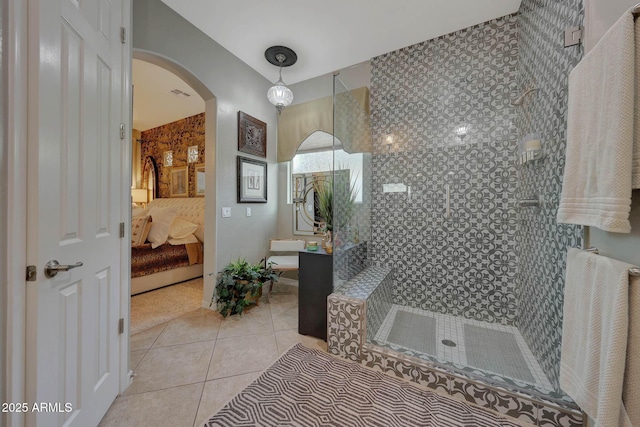 full bath featuring a walk in shower, visible vents, vanity, tile patterned floors, and ensuite bath