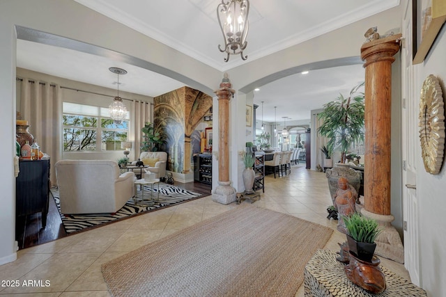 interior space featuring arched walkways, ornate columns, a wealth of natural light, and an inviting chandelier